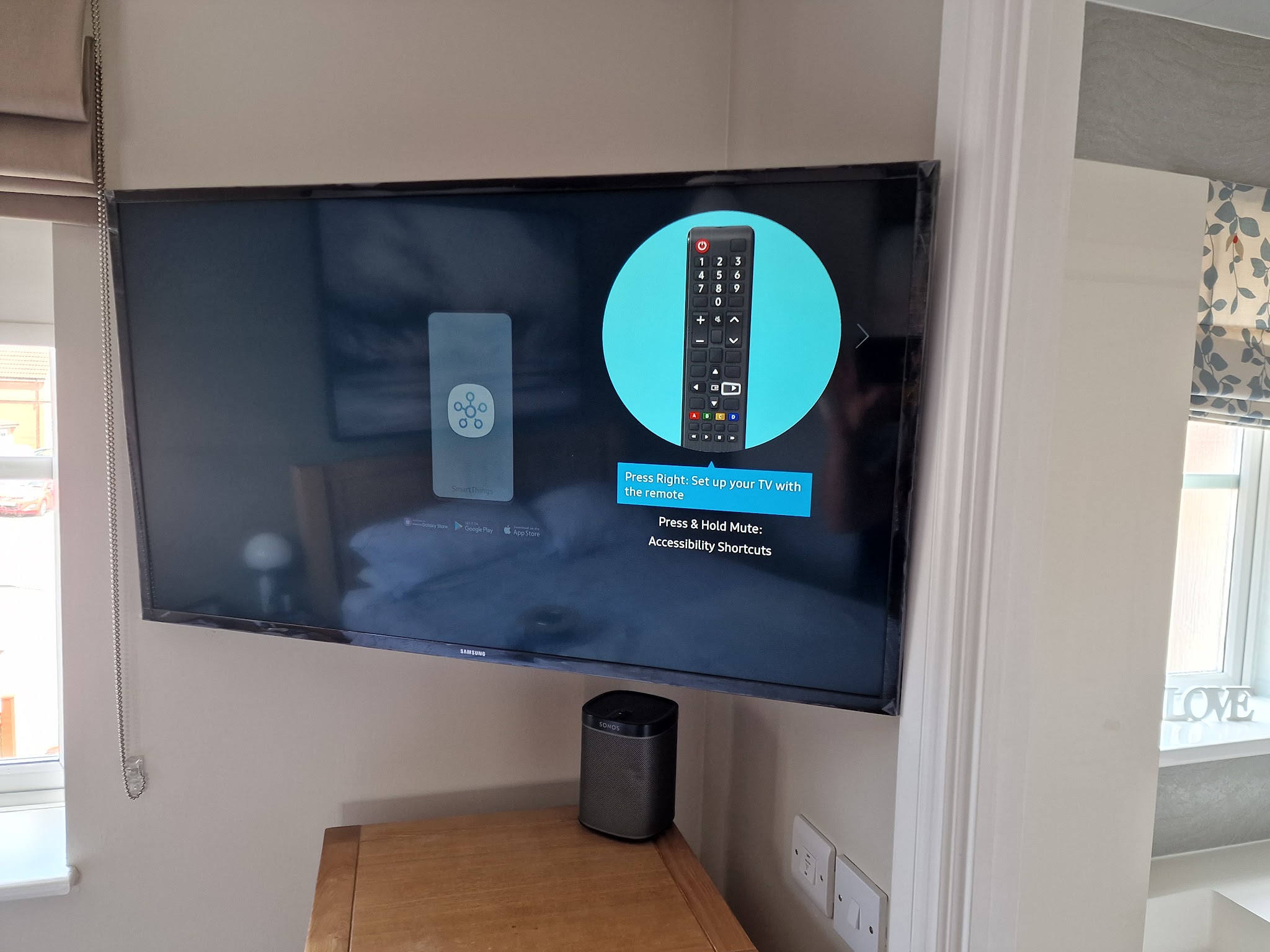 A wall-mounted smart TV with its set-up screen showing