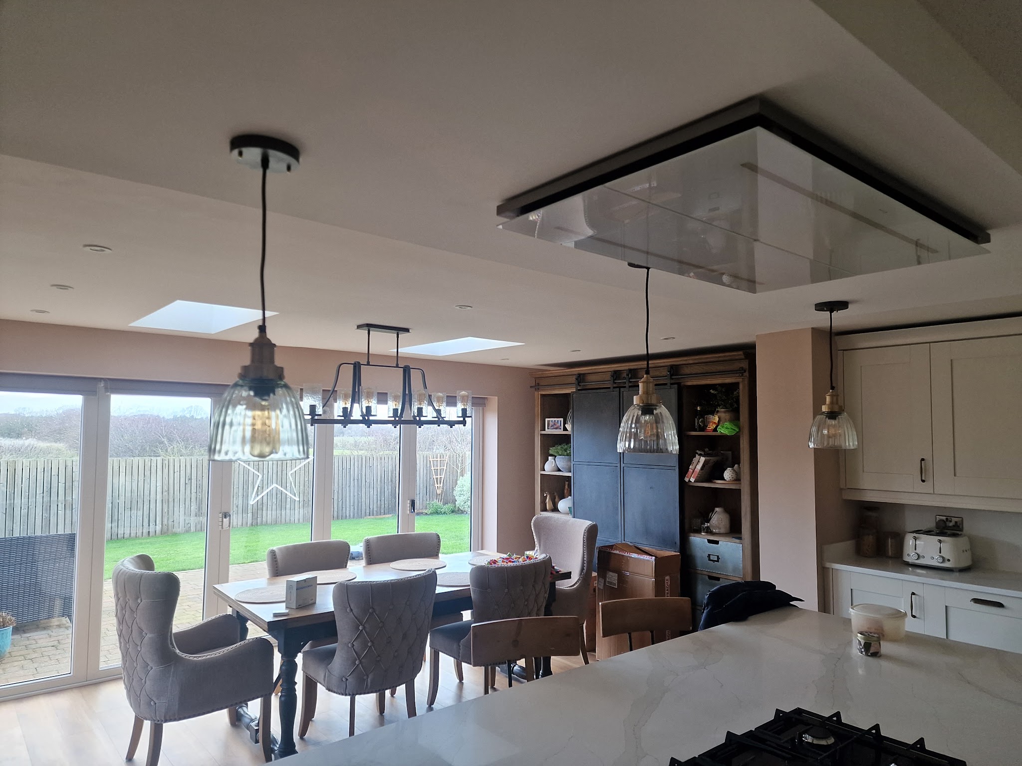 An open-plan kitchen and dining area with pendant lights